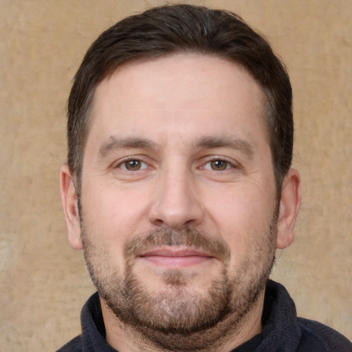 Joyful white adult male with short  brown hair and brown eyes