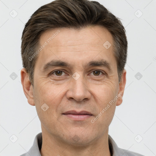 Joyful white adult male with short  brown hair and brown eyes