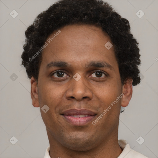 Joyful black young-adult male with short  brown hair and brown eyes