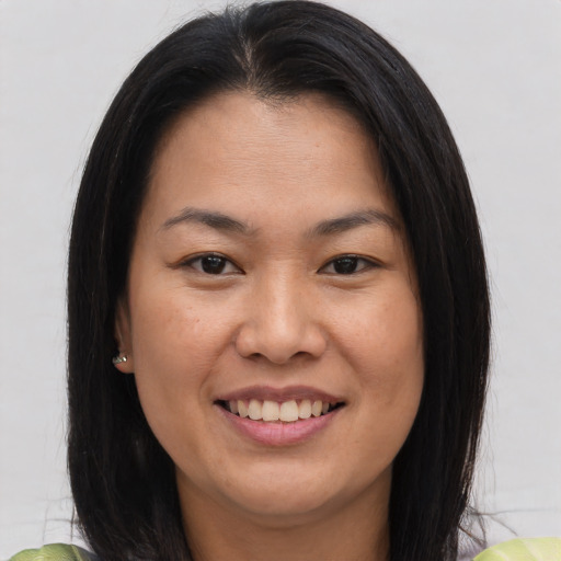 Joyful asian young-adult female with medium  brown hair and brown eyes
