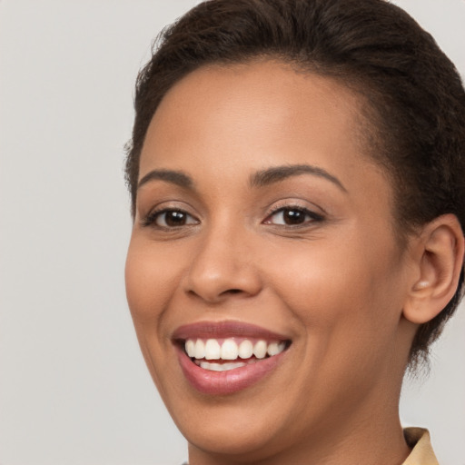 Joyful white young-adult female with short  brown hair and brown eyes