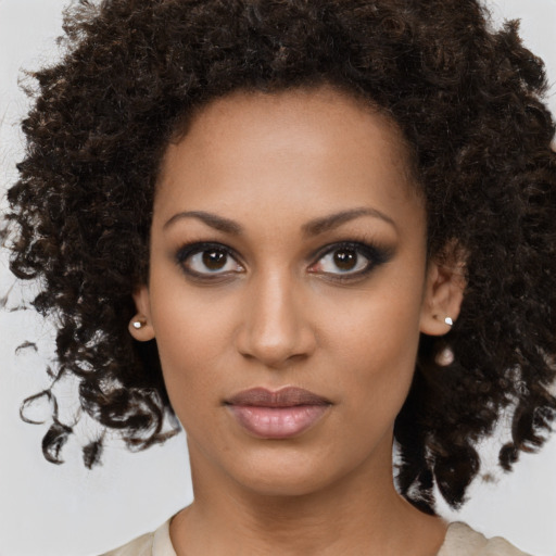 Neutral black young-adult female with medium  brown hair and brown eyes