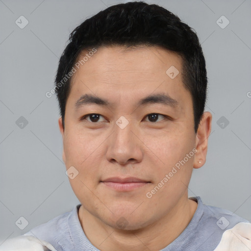 Joyful asian young-adult male with short  black hair and brown eyes