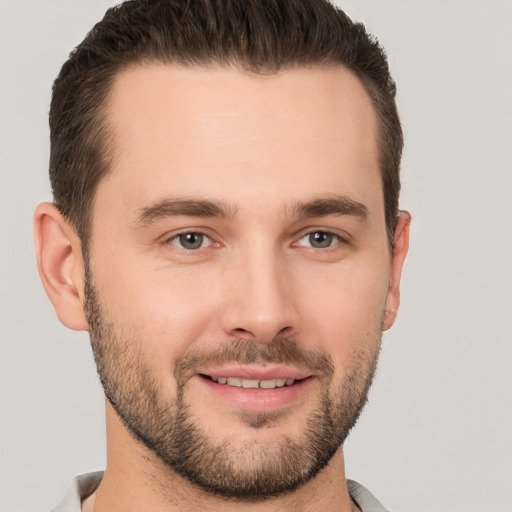 Joyful white young-adult male with short  brown hair and brown eyes