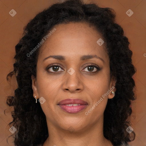 Joyful black young-adult female with long  brown hair and brown eyes