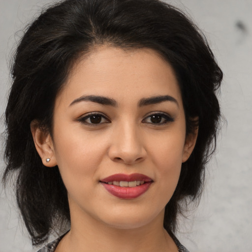 Joyful latino young-adult female with medium  black hair and brown eyes