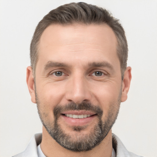 Joyful white adult male with short  brown hair and brown eyes