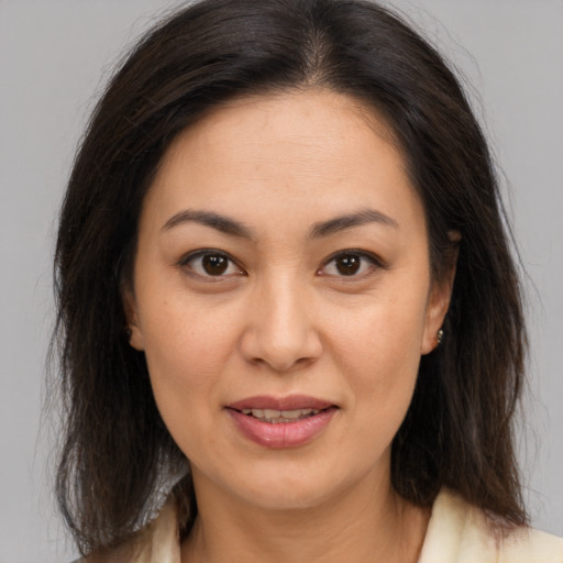 Joyful latino young-adult female with medium  brown hair and brown eyes