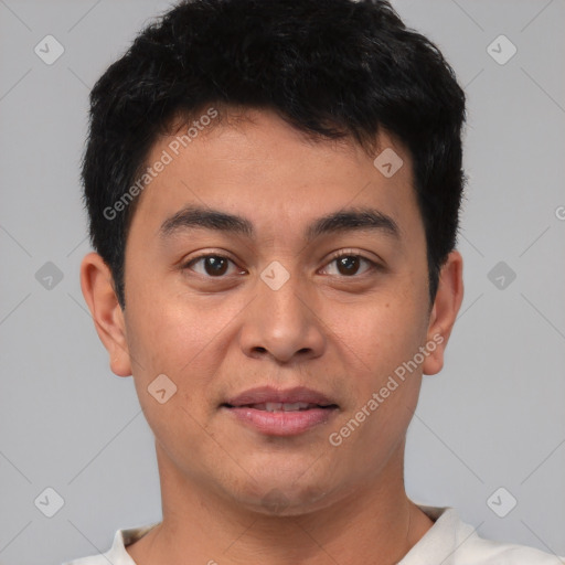 Joyful asian young-adult male with short  brown hair and brown eyes