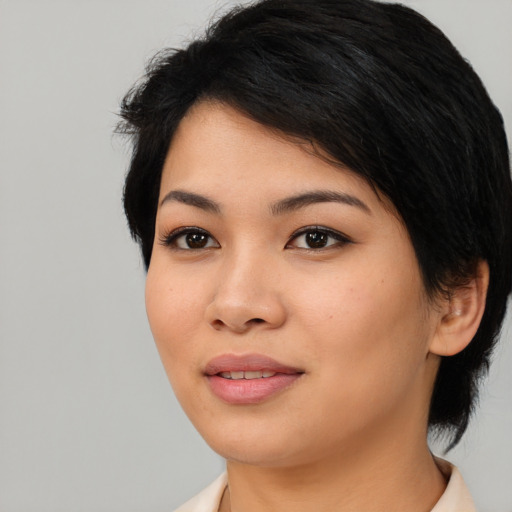 Joyful asian young-adult female with medium  black hair and brown eyes