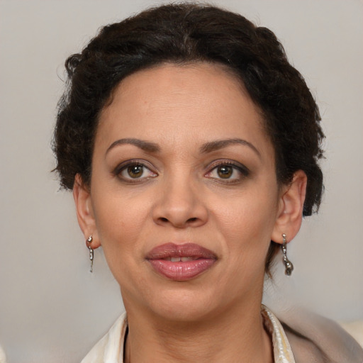 Joyful latino adult female with medium  brown hair and brown eyes