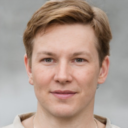 Joyful white adult male with short  brown hair and grey eyes