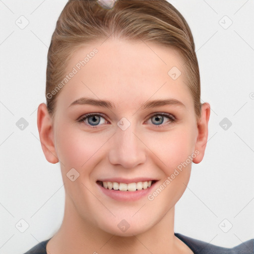 Joyful white young-adult female with short  brown hair and blue eyes