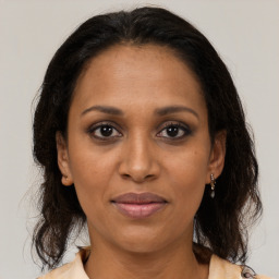 Joyful black adult female with medium  brown hair and brown eyes