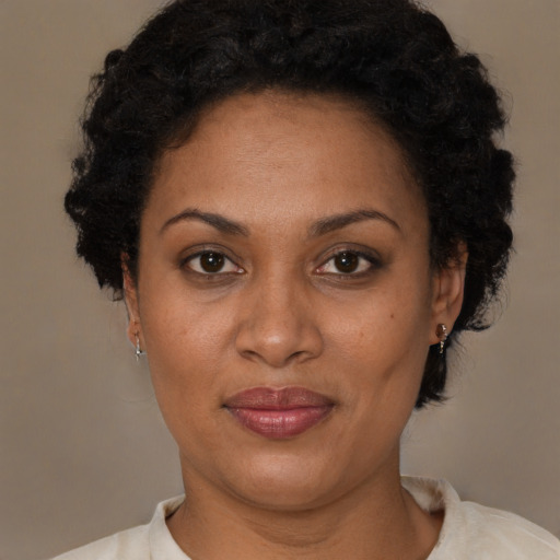 Joyful latino adult female with short  brown hair and brown eyes