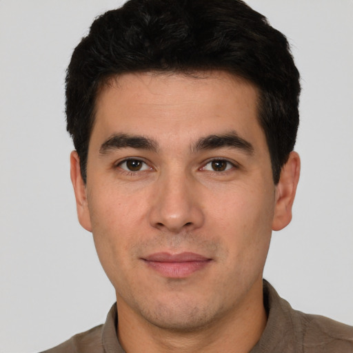 Joyful white young-adult male with short  black hair and brown eyes