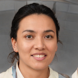 Joyful latino young-adult female with medium  brown hair and brown eyes