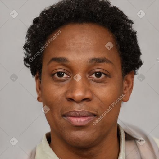 Joyful black adult male with short  brown hair and brown eyes