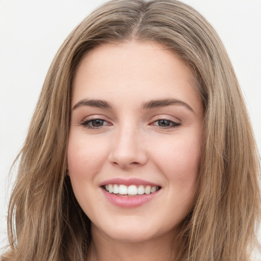 Joyful white young-adult female with long  brown hair and green eyes