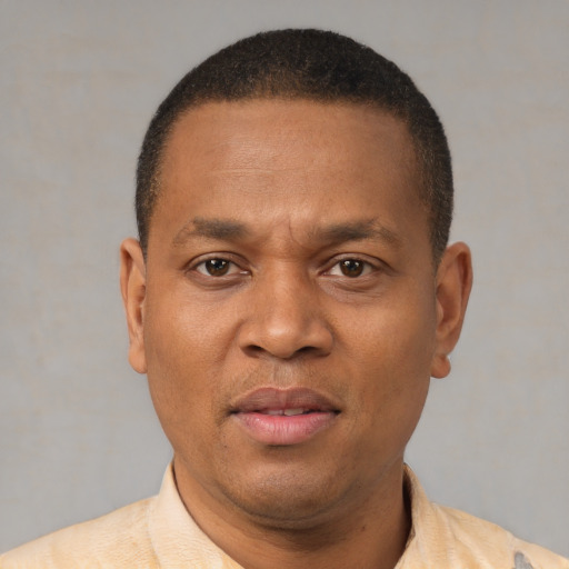 Neutral latino adult male with short  brown hair and brown eyes