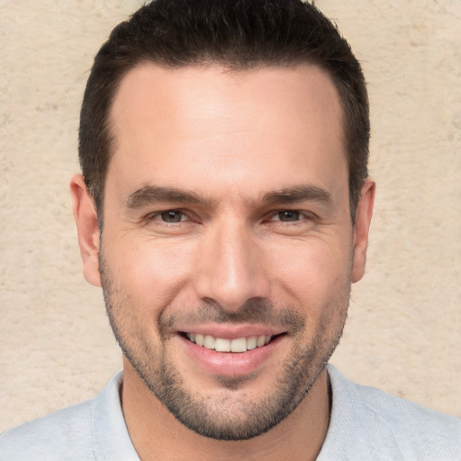 Joyful white young-adult male with short  brown hair and brown eyes