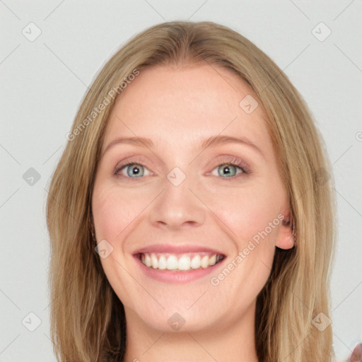 Joyful white young-adult female with long  brown hair and blue eyes