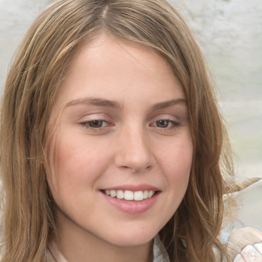 Joyful white young-adult female with long  brown hair and green eyes