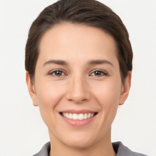 Joyful white young-adult female with short  brown hair and brown eyes