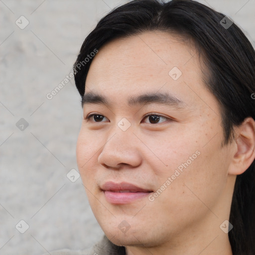 Joyful asian young-adult male with short  black hair and brown eyes