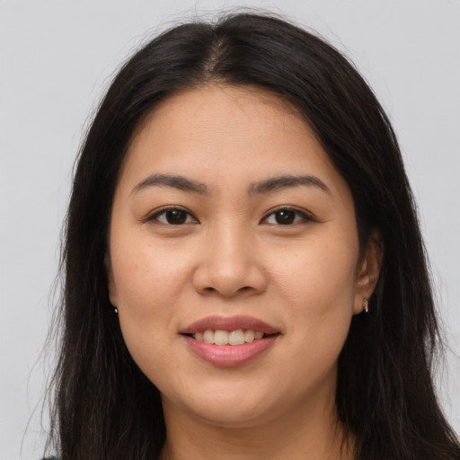 Joyful latino young-adult female with long  brown hair and brown eyes