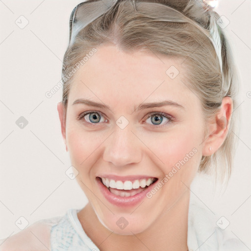 Joyful white young-adult female with medium  brown hair and blue eyes