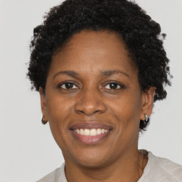 Joyful black adult female with short  brown hair and brown eyes