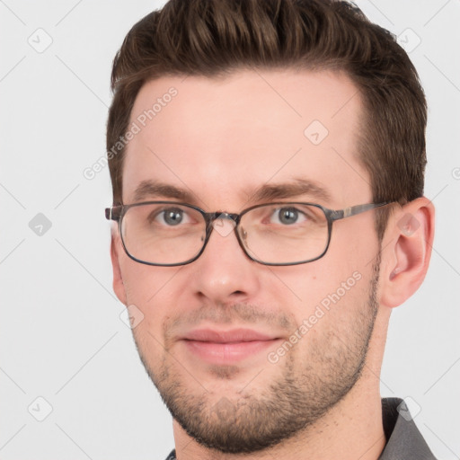 Joyful white young-adult male with short  brown hair and grey eyes