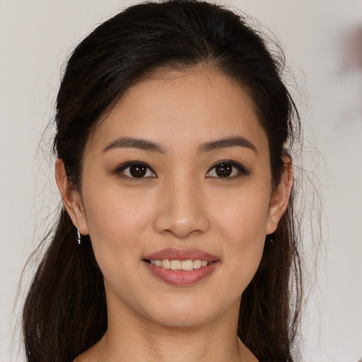 Joyful white young-adult female with long  brown hair and brown eyes