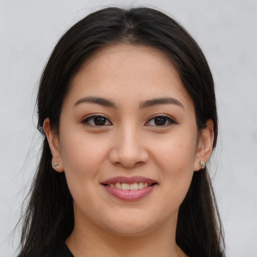 Joyful asian young-adult female with long  brown hair and brown eyes