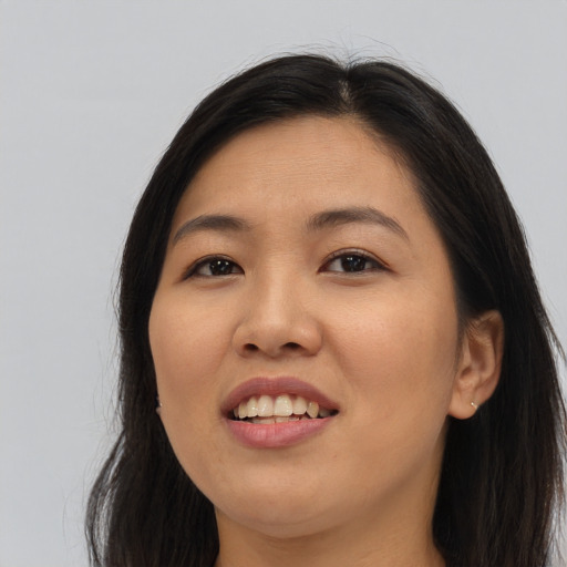 Joyful asian young-adult female with long  brown hair and brown eyes
