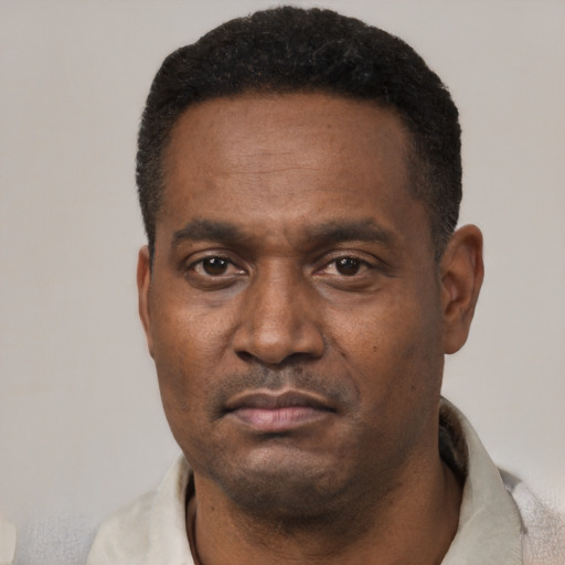 Neutral latino adult male with short  black hair and brown eyes