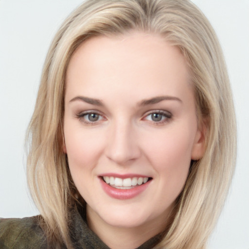 Joyful white young-adult female with long  brown hair and blue eyes