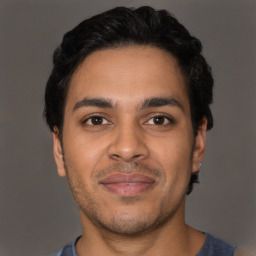 Joyful latino young-adult male with short  brown hair and brown eyes