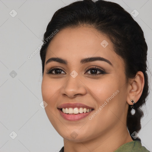 Joyful latino young-adult female with long  black hair and brown eyes