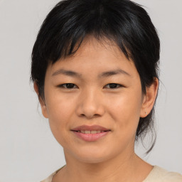 Joyful asian young-adult female with medium  black hair and brown eyes