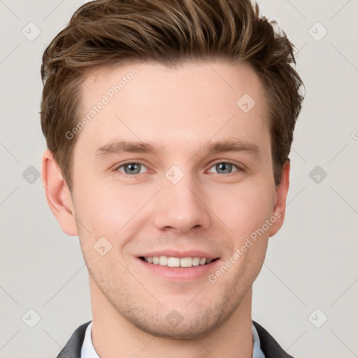 Joyful white young-adult male with short  brown hair and grey eyes