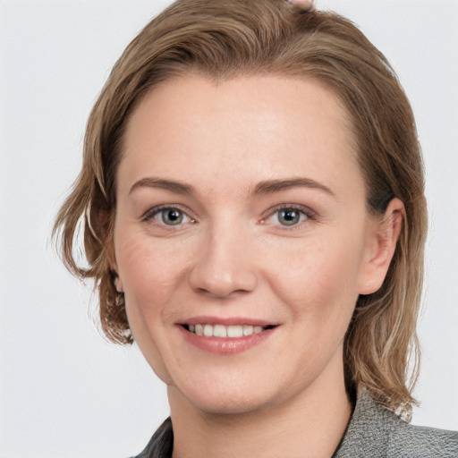 Joyful white young-adult female with medium  brown hair and blue eyes