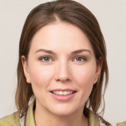 Joyful white young-adult female with medium  brown hair and grey eyes