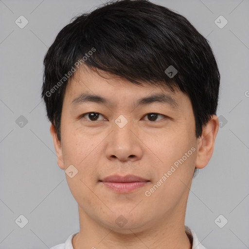 Joyful asian young-adult male with short  brown hair and brown eyes