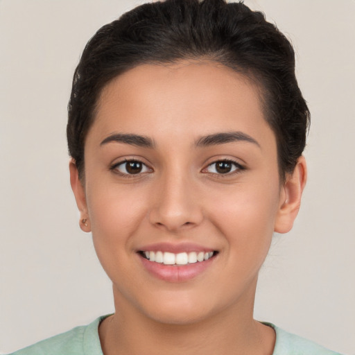 Joyful white young-adult female with short  brown hair and brown eyes