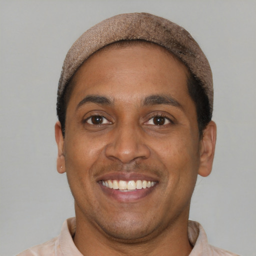 Joyful latino young-adult male with short  brown hair and brown eyes