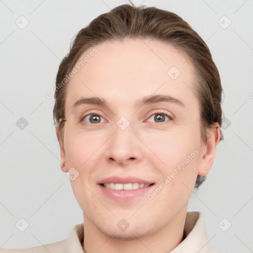 Joyful white young-adult female with short  brown hair and grey eyes