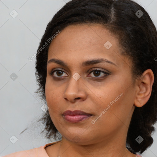 Joyful black young-adult female with medium  brown hair and brown eyes