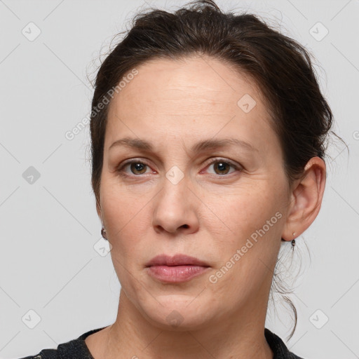 Joyful white adult female with medium  brown hair and grey eyes